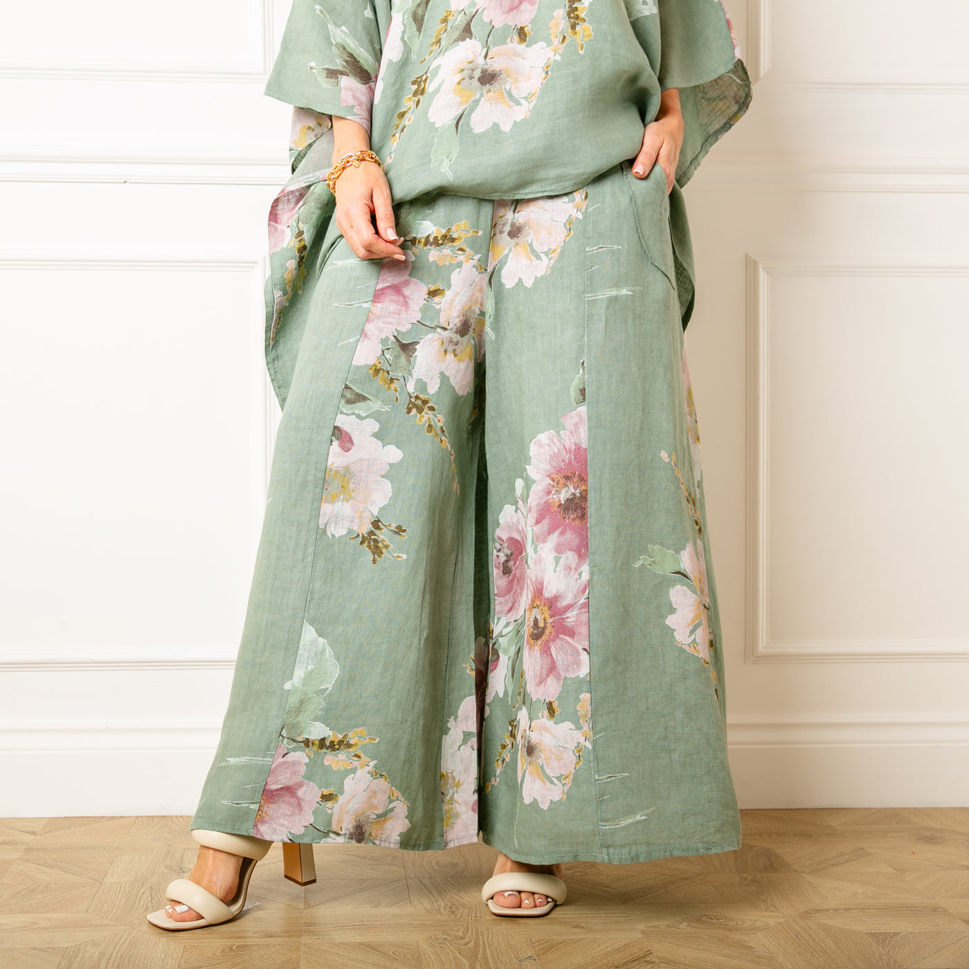 The sage green Bouquet Print Linen Trousers featuring a large beautiful floral print perfect for summer